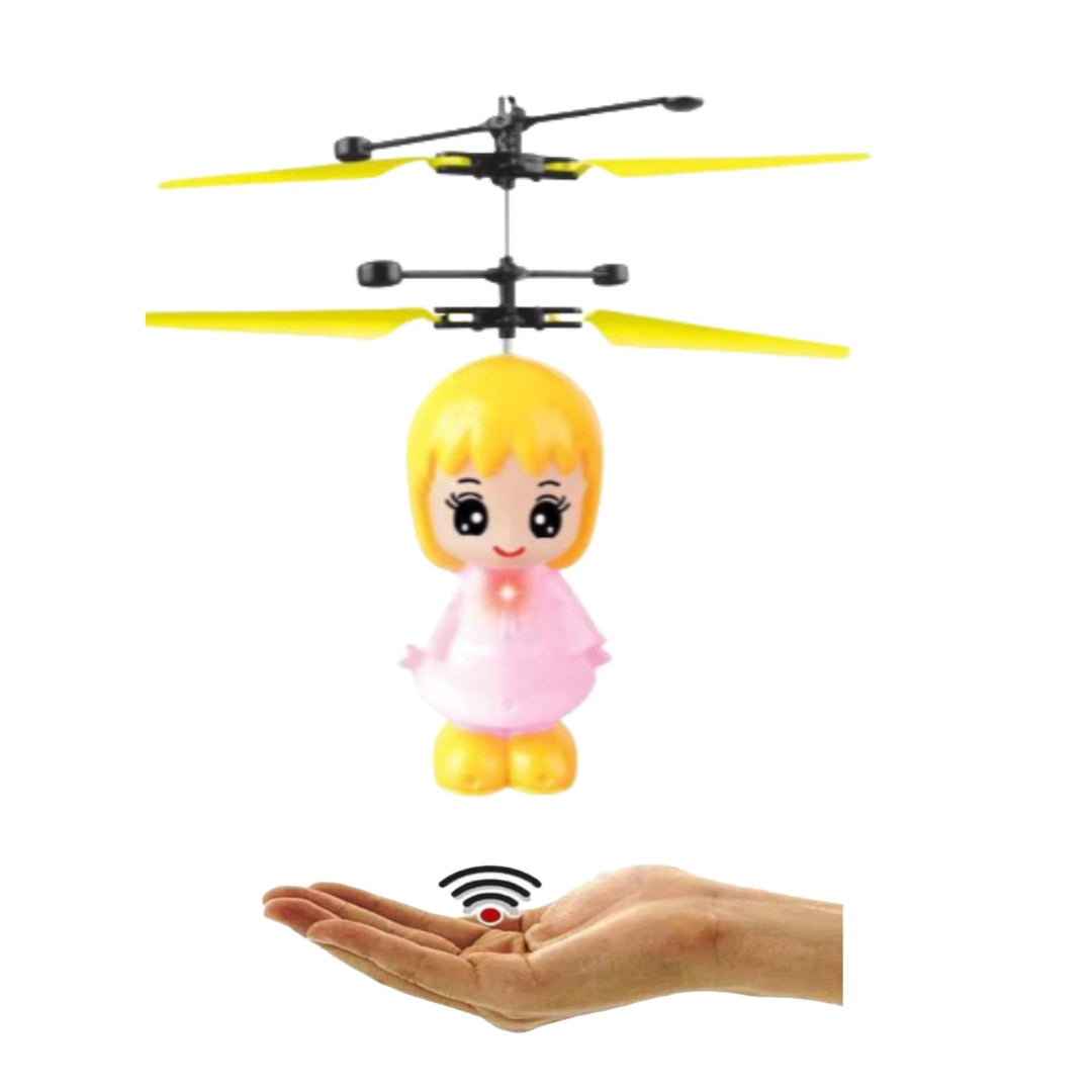 A small toy fairy doll in pink with yellow wings, suspended in the air above a hand, illustrating the hand sensor control feature.