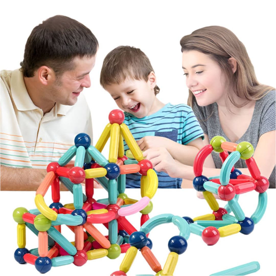A family playing with a colorful magnetic building toy set, including sticks and balls.