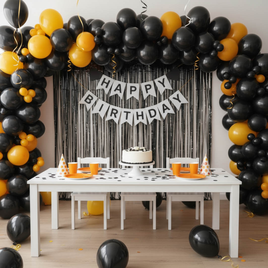 Birthday party setup with orange and yellow balloons, a cake, and 'Happy Birthday' banner.