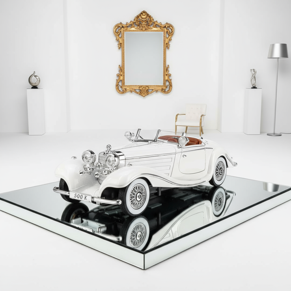 Model of a vintage car on a reflective surface with a decorative mirror in the background