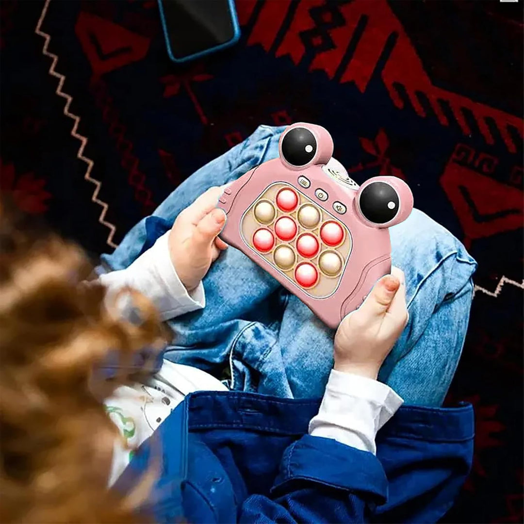 Child holding a pink toy phone with a patterned rug in the background