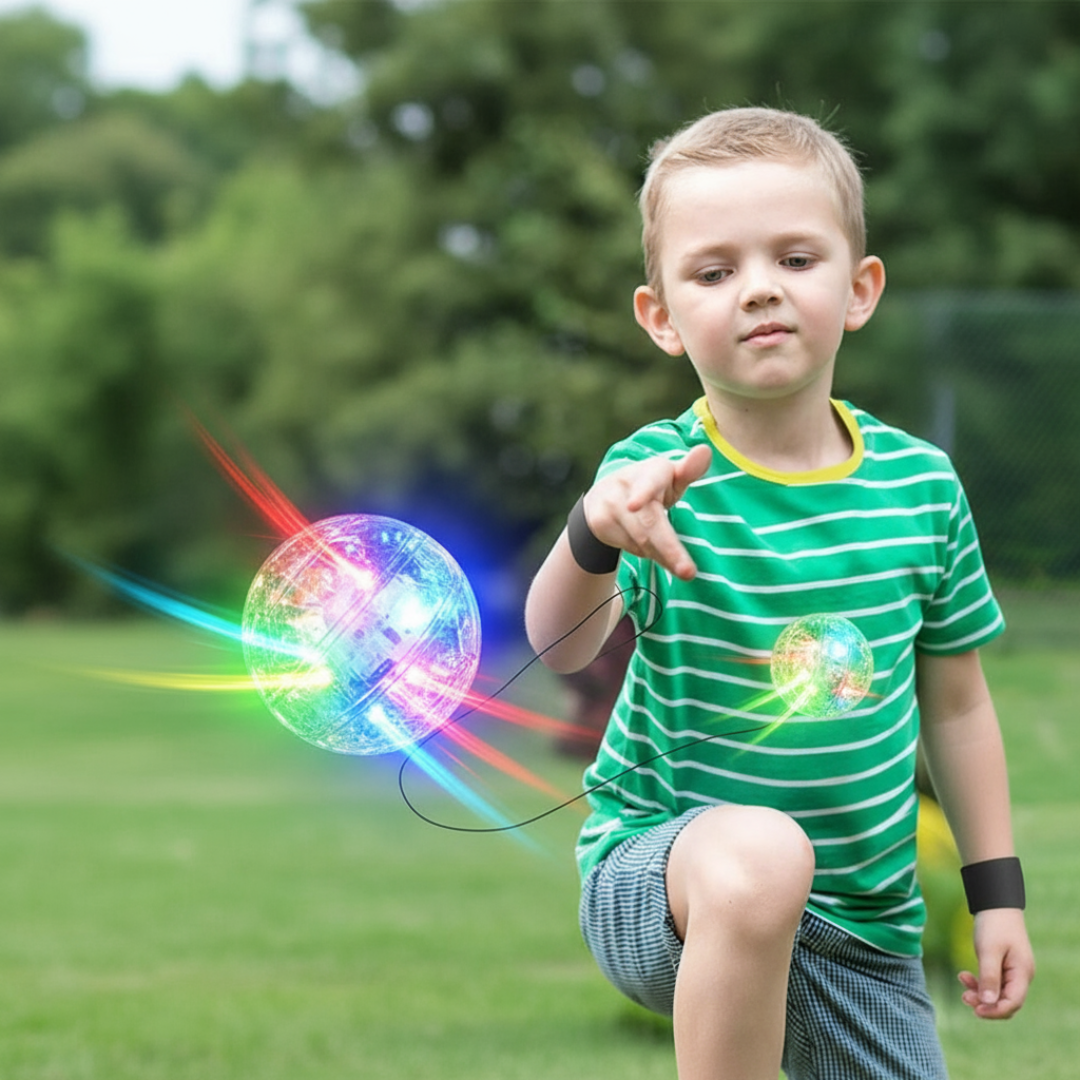 Child playing with a colorful发光球 outdoors
