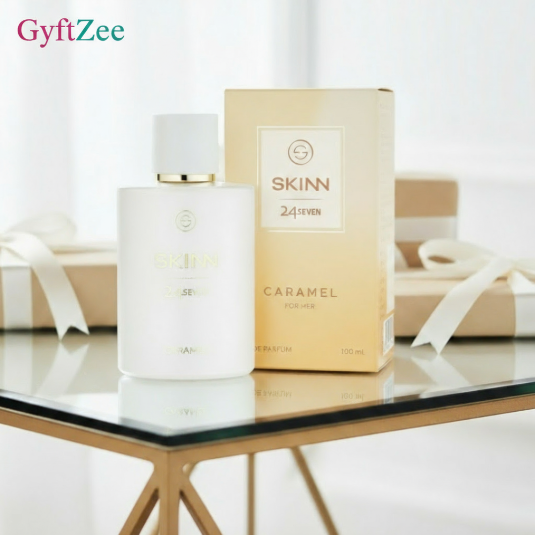Skinn Caramel perfume bottle and packaging on a glass table with white background