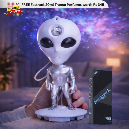 Alien-shaped lamp held by a hand with a Fastrack perfume box in the background