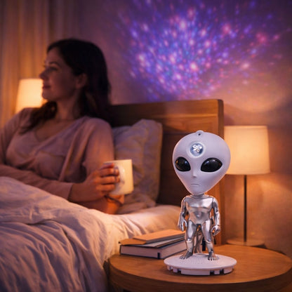 Woman in bed with a cup, alien robot night light on a table, colorful projection on wall