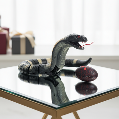 Toy snake on a reflective surface with a blurred background