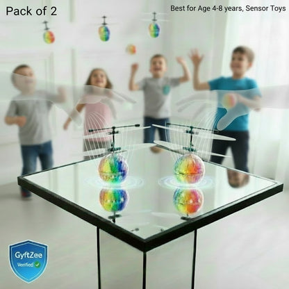 Children playing with colorful sensor toys on a table, with a blurred background. Hand Sensor Flying LED ball