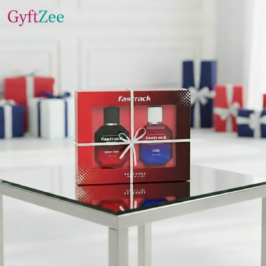 Fasttrack perfume set packaging on a glass table with gift boxes in the background