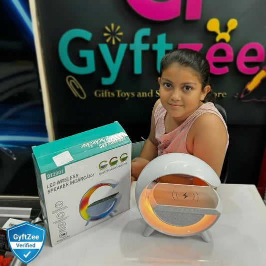 Child with LED wireless speaker and packaging in front of a GyftZee branded backdrop