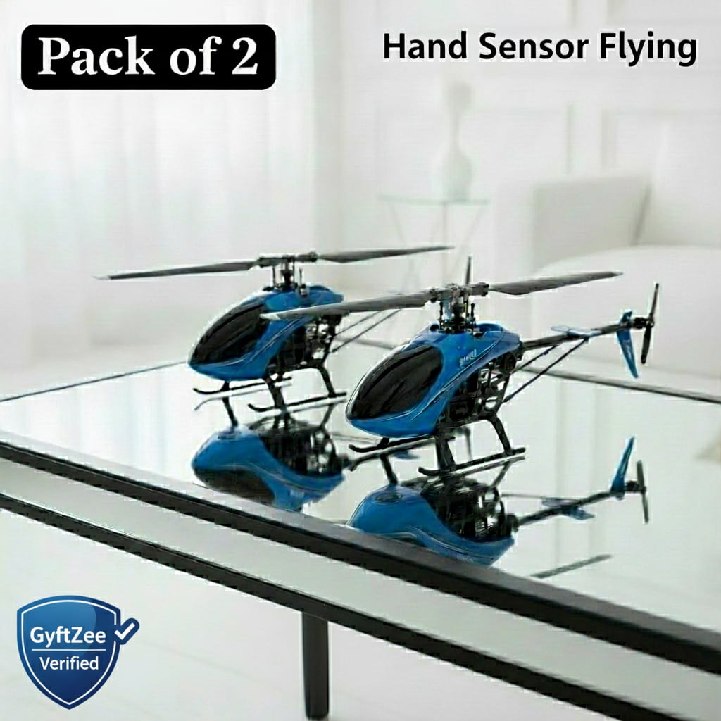 Two blue and black toy helicopters on a glass table with 'Pack of 2' and 'Hand Sensor Flying' text above.