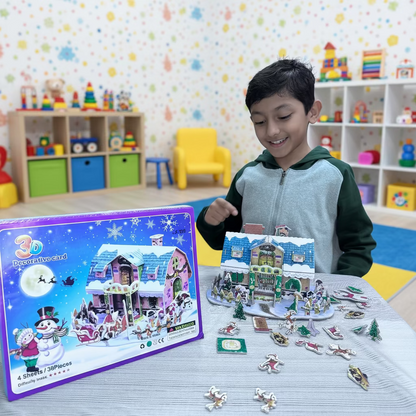Child playing with a 3D puzzle of a snowy village scene on a table.