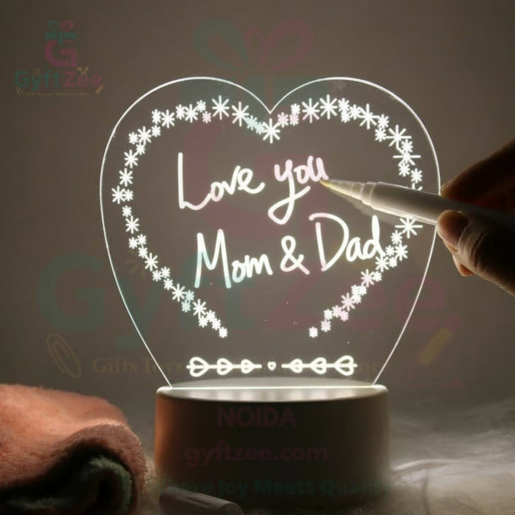 A hand writing on a illuminated acrylic board with a marker. The board is rectangular with a white base and transparent front, displaying a message in a playful font.