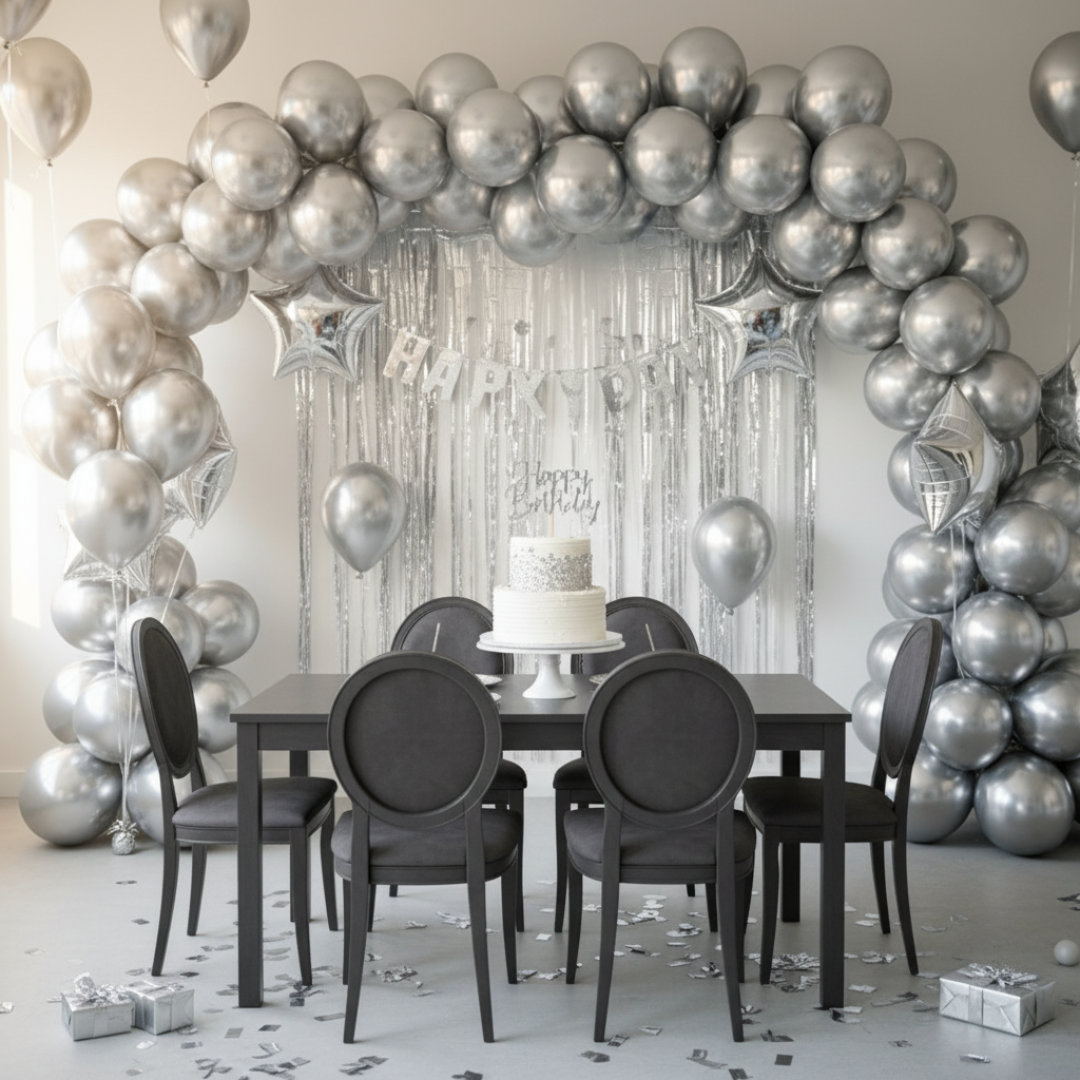 Dining room with silver balloon arch and 'Happy Birthday' banner