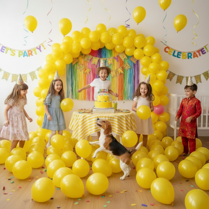 Children and a dog celebrating a birthday with yellow balloons and decorations.