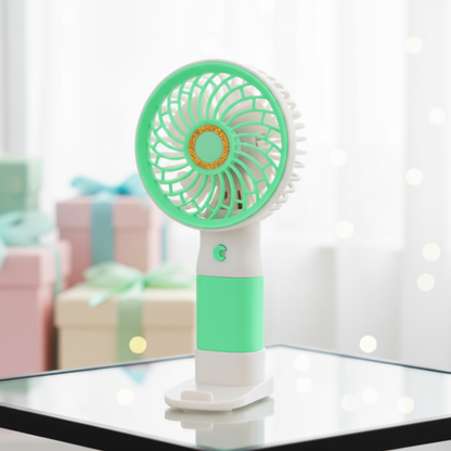 Portable fan with mint green and white design on a reflective surface