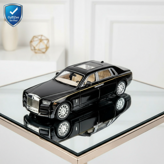 Black luxury car model on a reflective surface with a white background