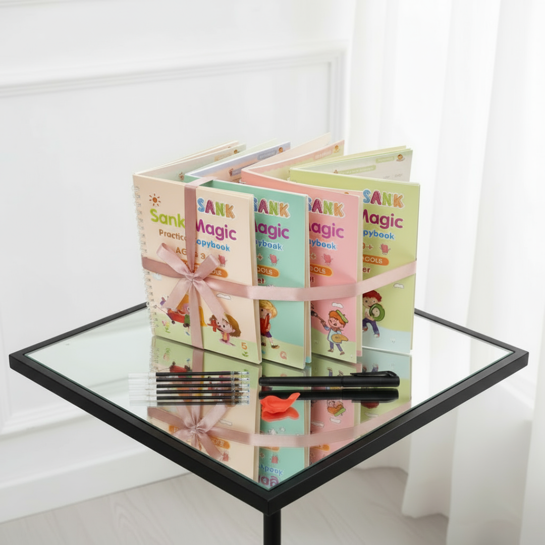 Children's books titled 'Sank Magic' on a glass table with a white curtain background