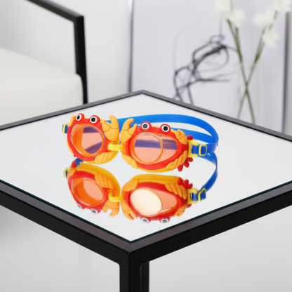 Colorful swim goggles with crab design on a reflective surface