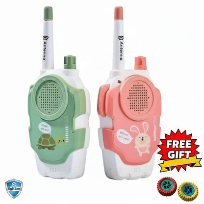 Two colorful walkie-talkies, one green and one pink, with cartoon characters on a white background. There is a 'Free Gift' badge with two small toys on a red star-shaped background.
