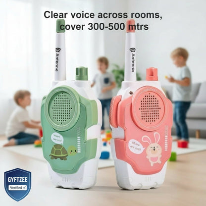 Two walkie-talkies, one green and one pink, with children playing in the background.