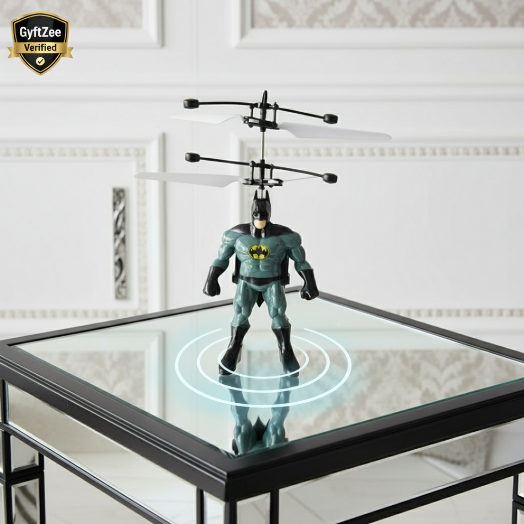 Bat-shaped toy with remote control on a glass table