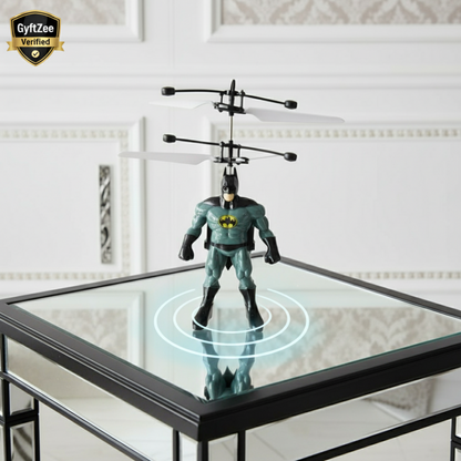 Bat-shaped toy with remote control on a glass table