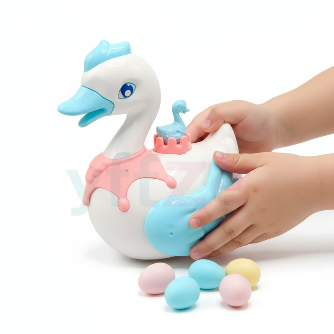 Toy swan with a baby swan inside, held by a hand on a white background